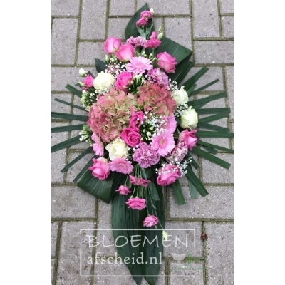 Compact gestoken roze rouwarrangement